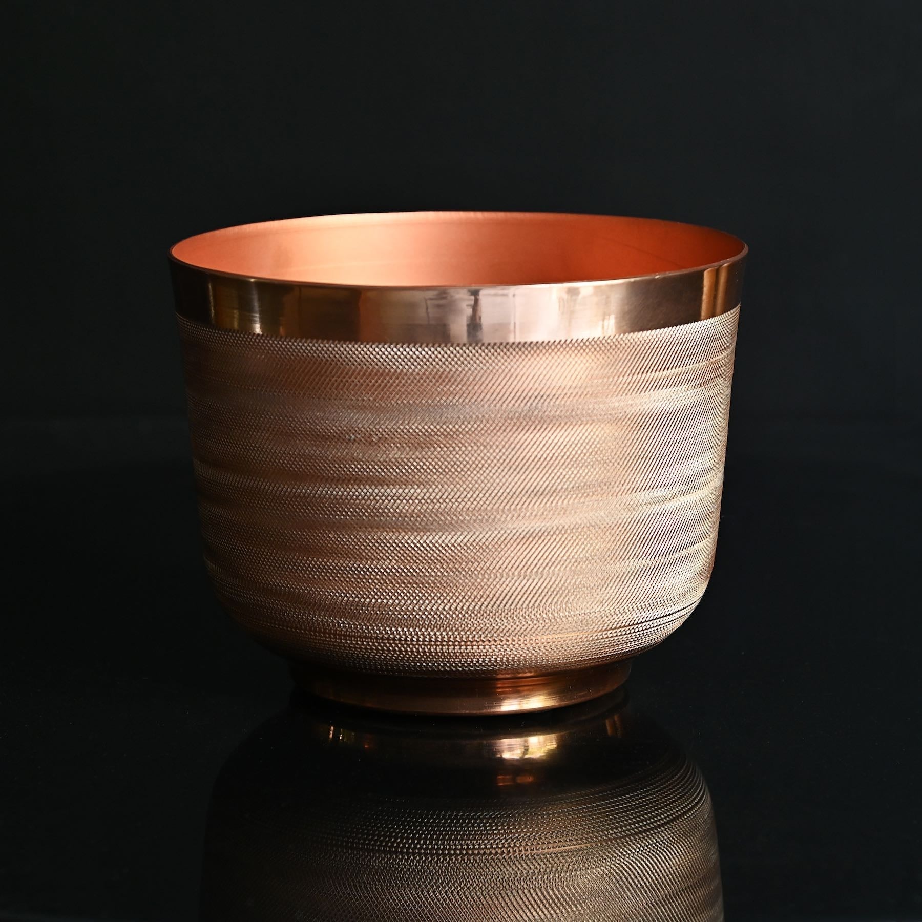 round metal planter with copper finish